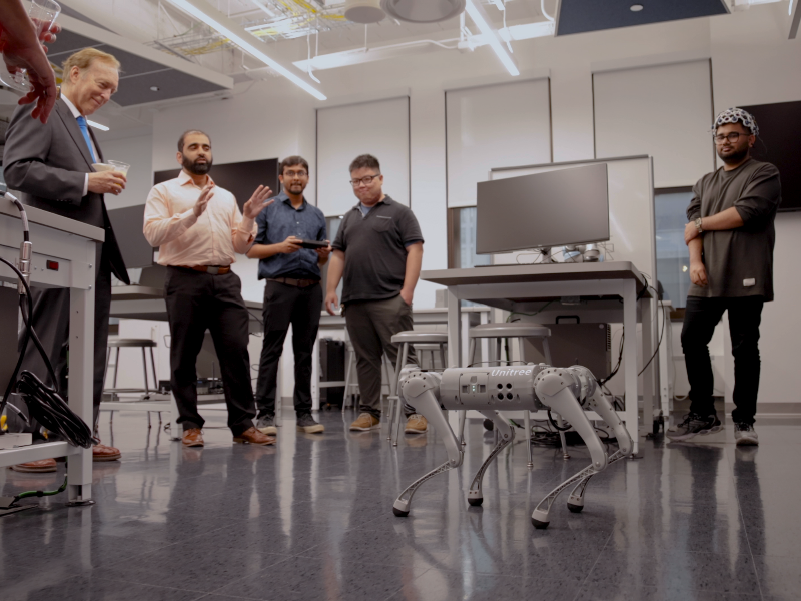Students demonstrate a quadruped robot in the robotics lab 